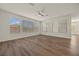 Empty living room featuring wood-look floors, neutral walls, and large windows for natural light at 8106 Skye Glen St, Las Vegas, NV 89166
