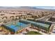 Aerial view of the community featuring three tennis courts with mountain views at 8106 Skye Glen St, Las Vegas, NV 89166