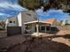 View of backyard with patio, chairs, and landscaping at 8166 Tone St, Las Vegas, NV 89123