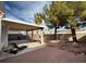 Spacious backyard featuring a covered patio and stone landscaping, perfect for relaxing at 8166 Tone St, Las Vegas, NV 89123
