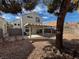 Landscaped backyard with covered patio and lounge chair at 8166 Tone St, Las Vegas, NV 89123
