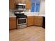 Functional kitchen featuring wood cabinets, stainless appliances, and laminate flooring at 8166 Tone St, Las Vegas, NV 89123