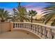 Balcony view overlooking a golf course and palm trees, offering a serene and tropical setting at 8390 Carmel Ridge Ct, Las Vegas, NV 89113