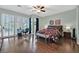 Spacious bedroom with plantation shutters, dark wood floors, and a ceiling fan at 8390 Carmel Ridge Ct, Las Vegas, NV 89113