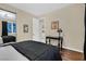Bedroom features wood floors, modern lighting, a window with curtains, and decorative wall art at 8390 Carmel Ridge Ct, Las Vegas, NV 89113