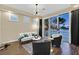 Cozy living room featuring access to a balcony, modern furniture, and neutral decor at 8390 Carmel Ridge Ct, Las Vegas, NV 89113