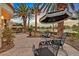 Outdoor patio featuring a charming outdoor seating area with palm trees and an umbrella at 8390 Carmel Ridge Ct, Las Vegas, NV 89113
