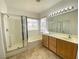 Bathroom showcasing double vanity, shower, soaking tub, and tile flooring at 8576 Peaceful Dreams St, Las Vegas, NV 89139