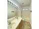 Bright bathroom featuring a double vanity and a shower-over-tub setup with white tiled walls at 8576 Peaceful Dreams St, Las Vegas, NV 89139