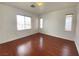 Bright bedroom featuring hardwood floors, white walls, and natural light from multiple windows at 8576 Peaceful Dreams St, Las Vegas, NV 89139