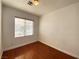 Bedroom featuring hardwood floors, white walls, and natural light from a window at 8576 Peaceful Dreams St, Las Vegas, NV 89139
