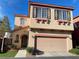 Charming two-story home featuring a stucco facade, arched entry, and an attached two-car garage at 8576 Peaceful Dreams St, Las Vegas, NV 89139