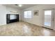 Bright living room with tile flooring and large window, next to door with security bars at 8576 Peaceful Dreams St, Las Vegas, NV 89139
