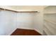 Walk-in closet featuring hardwood flooring and built-in shelving at 8576 Peaceful Dreams St, Las Vegas, NV 89139