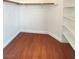 Walk-in closet showcasing hardwood flooring and built-in shelving at 8576 Peaceful Dreams St, Las Vegas, NV 89139