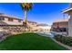 Private backyard with artificial grass, pool and table set at 9020 Loggers Mill Ave, Las Vegas, NV 89143