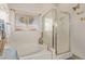 Well-lit bathroom featuring a soaking tub, glass-enclosed shower, and a large window at 9020 Loggers Mill Ave, Las Vegas, NV 89143