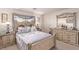 Bright main bedroom features a decorative bed frame, dresser, and bedside tables at 9020 Loggers Mill Ave, Las Vegas, NV 89143