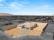Aerial view of the home showcasing the desert landscaping, two car garage, and spacious lot at 9930 Zakos Ct, Las Vegas, NV 89149