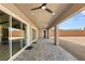 The backyard patio has a ceiling fan, a stone paver floor, and sliding glass doors to the home's interior at 9930 Zakos Ct, Las Vegas, NV 89149