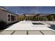 Relaxing backyard featuring a spa, outdoor lounge with pergola, and privacy landscaping at 9930 Zakos Ct, Las Vegas, NV 89149