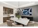 Elegant dining room with a large table, stylish chairs, and a modern chandelier at 9930 Zakos Ct, Las Vegas, NV 89149