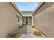 Charming front entrance with brick pathway and landscaped garden at 9930 Zakos Ct, Las Vegas, NV 89149