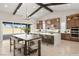 Bright kitchen features an island with seating, stainless appliances, and large sliding doors to the backyard at 9930 Zakos Ct, Las Vegas, NV 89149