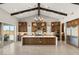 Gourmet kitchen with a large island, stainless steel appliances, custom cabinets, and backyard view at 9930 Zakos Ct, Las Vegas, NV 89149