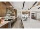 Spacious kitchen with stainless steel appliances, large island, custom cabinetry, and lots of natural light at 9930 Zakos Ct, Las Vegas, NV 89149