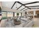 Spacious living room featuring exposed beams, fireplace, and access to the backyard at 9930 Zakos Ct, Las Vegas, NV 89149
