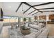 Spacious living room featuring exposed beams, fireplace, and access to the backyard at 9930 Zakos Ct, Las Vegas, NV 89149
