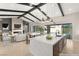 Bright and open-concept living and kitchen area with fireplace, TV, island, and large sliding doors at 9930 Zakos Ct, Las Vegas, NV 89149