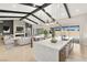 Open-concept living room and kitchen with island, fireplace, TV, and sliding doors to the backyard at 9930 Zakos Ct, Las Vegas, NV 89149