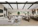 Open concept living room with dining area, kitchen, and fireplace at 9930 Zakos Ct, Las Vegas, NV 89149