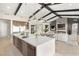 Spacious open-concept living room and kitchen with island, fireplace, TV, and great natural light at 9930 Zakos Ct, Las Vegas, NV 89149