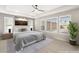 Serene primary bedroom featuring a plush bed, ample natural light from large windows, and stylish decor at 9930 Zakos Ct, Las Vegas, NV 89149