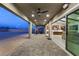 Covered patio with ceiling fans and recessed lighting, seamlessly connecting indoor and outdoor spaces at 9930 Zakos Ct, Las Vegas, NV 89149