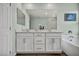 Bathroom boasting double sink vanity, soaking tub, and modern nautical themed decorations at 9983 Cluny Ave, Las Vegas, NV 89178