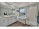 This bathroom features a dual vanity, bathtub, and a separate glass-enclosed shower at 9983 Cluny Ave, Las Vegas, NV 89178