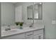 The bathroom offers a dual vanity with white cabinets, stylish fixtures, and decorative accents at 9983 Cluny Ave, Las Vegas, NV 89178