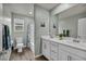 This bathroom offers a dual vanity with white cabinets and a full tub and shower at 9983 Cluny Ave, Las Vegas, NV 89178