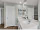 Bright bathroom featuring a double sink vanity with a modern quartz countertop at 9983 Cluny Ave, Las Vegas, NV 89178