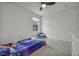 Bedroom with light blue accents, a small bed with a blue comforter, and a beanbag chair at 9983 Cluny Ave, Las Vegas, NV 89178