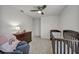 Bedroom features dark wood crib, changing table, glider chair, and neutral decor at 9983 Cluny Ave, Las Vegas, NV 89178