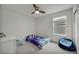 Bedroom with light blue accents, a small bed with a blue comforter, and a beanbag chair at 9983 Cluny Ave, Las Vegas, NV 89178