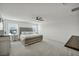 Spacious bedroom showcases a large bed, plush carpet and a ceiling fan at 9983 Cluny Ave, Las Vegas, NV 89178