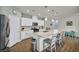 Bright kitchen features white cabinets, stainless appliances, and a large island with counter seating at 9983 Cluny Ave, Las Vegas, NV 89178