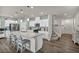 Open kitchen with a large center island and seating, next to the staircase at 9983 Cluny Ave, Las Vegas, NV 89178