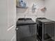 Laundry room featuring modern side-by-side Samsung washer and dryer units and shelving at 9983 Cluny Ave, Las Vegas, NV 89178